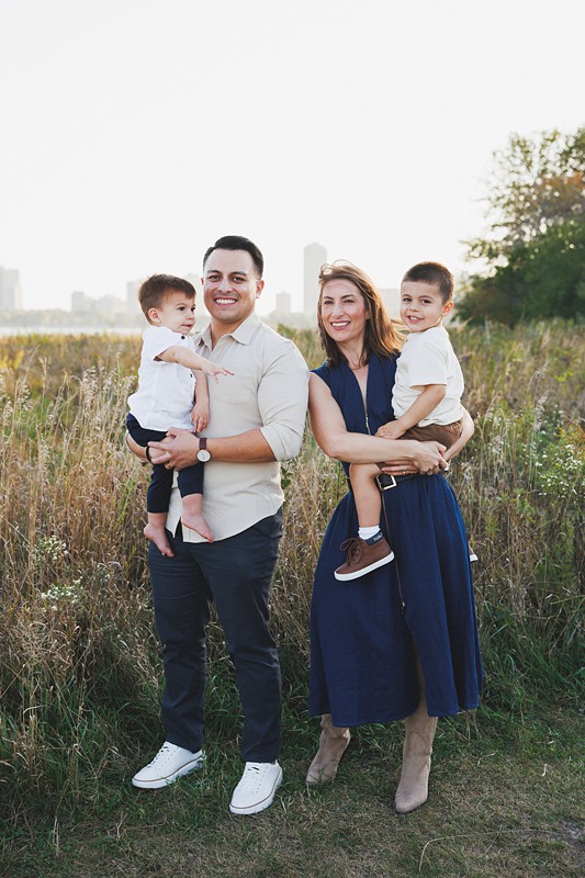 a well dressed family poses at montrose harbor in chicago for photos