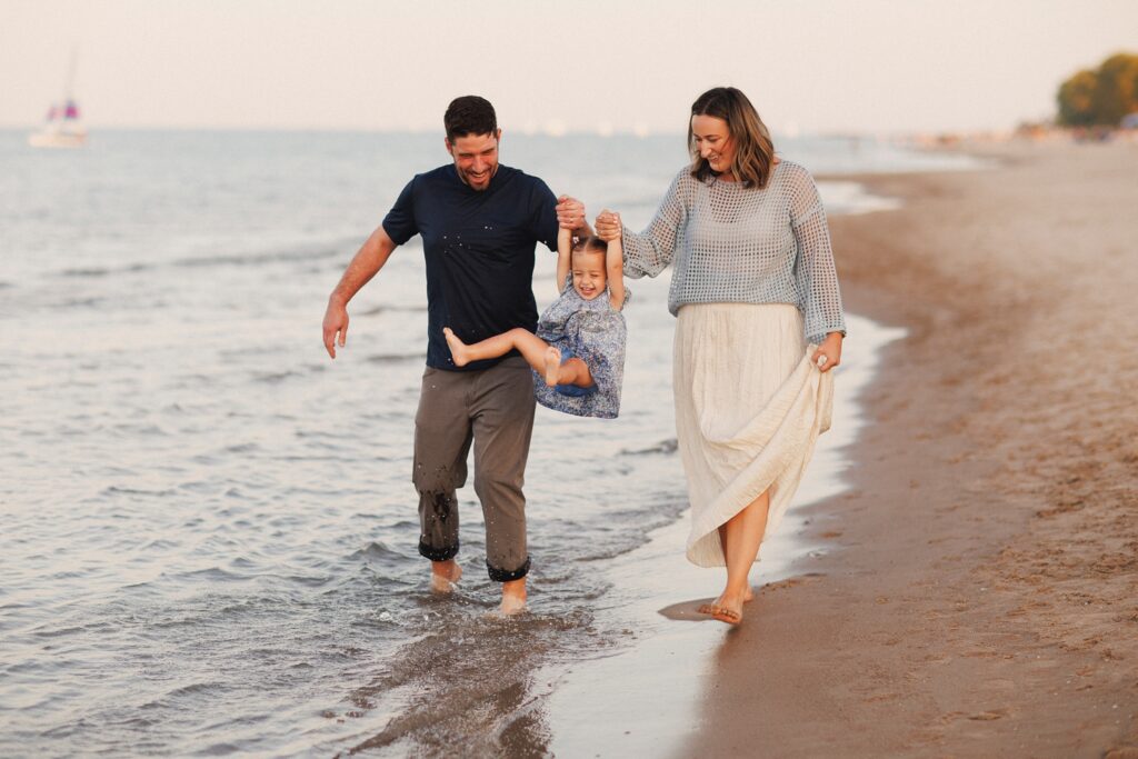 Family photos in Chicago at golden hour with parents and kids walking near the lakefront