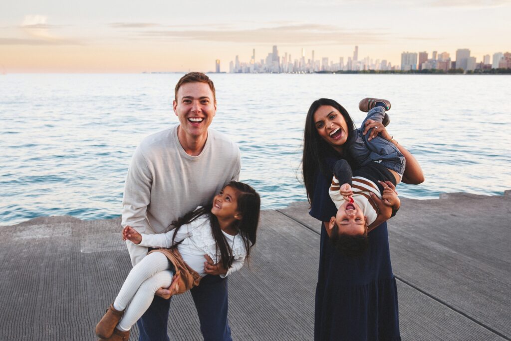 Family photos in Chicago at golden hour with parents and kids walking near the lakefront