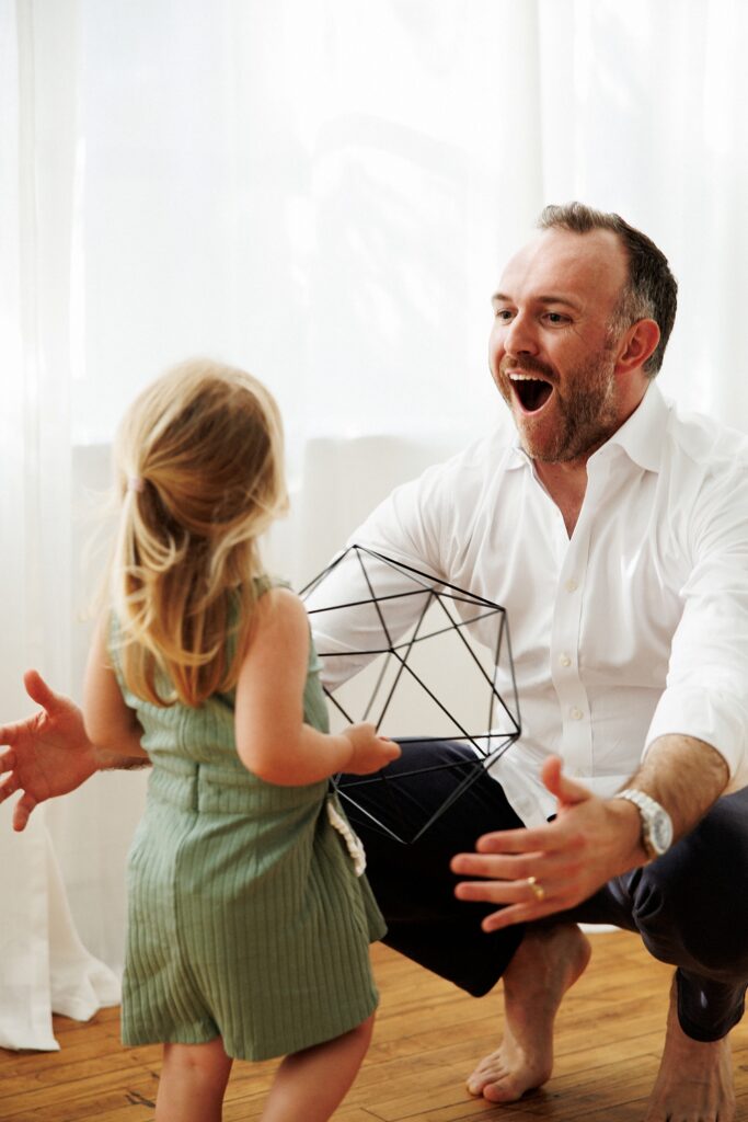 Indoor family portrait with soft natural window light and neutral outfits in Chicago home