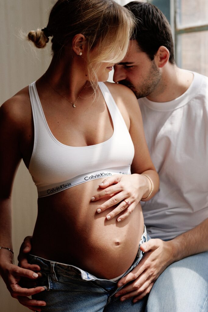 a couple poses for a maternity photoshoot in chicago