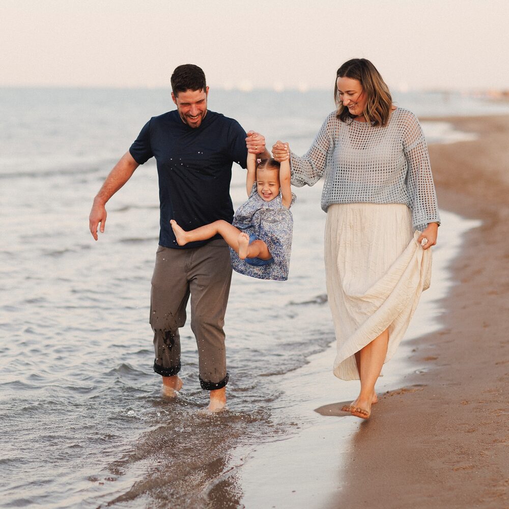 Family photos in Chicago at golden hour with parents and kids walking near the lakefront
