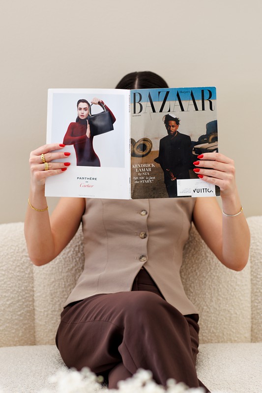 Hair dresser lauren Cikulin poses with a fashion magazine during her branding photos in chicago hair salon