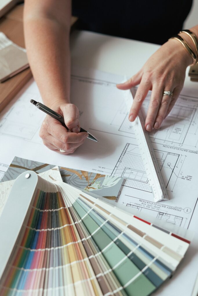 detail of hands writing notes about interior deisng