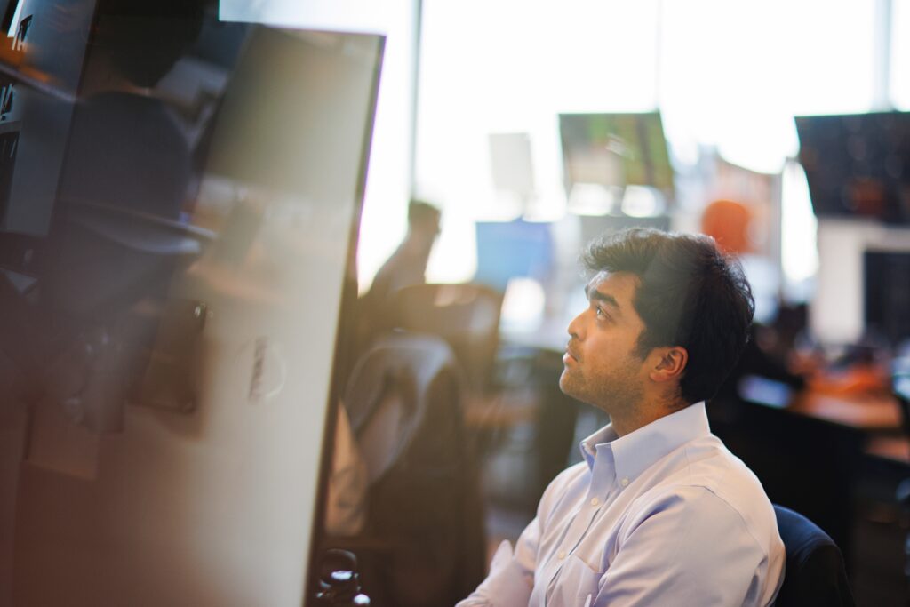 a financial trader looks at a computer at work at ready state financial firm