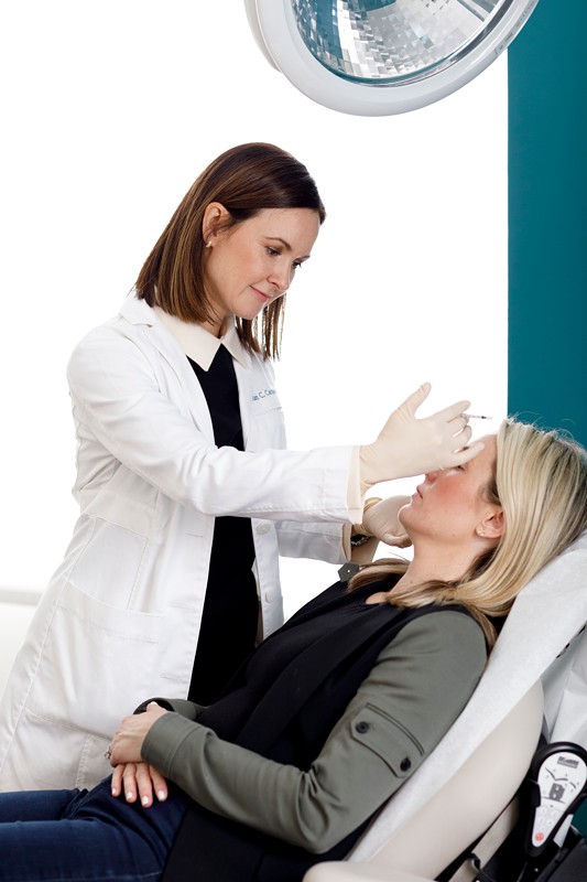 dr. carqueville administers botox to a patient at the derm institute of chicago