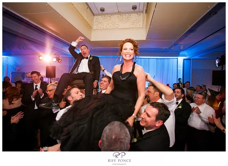 parents on chairs during the horah