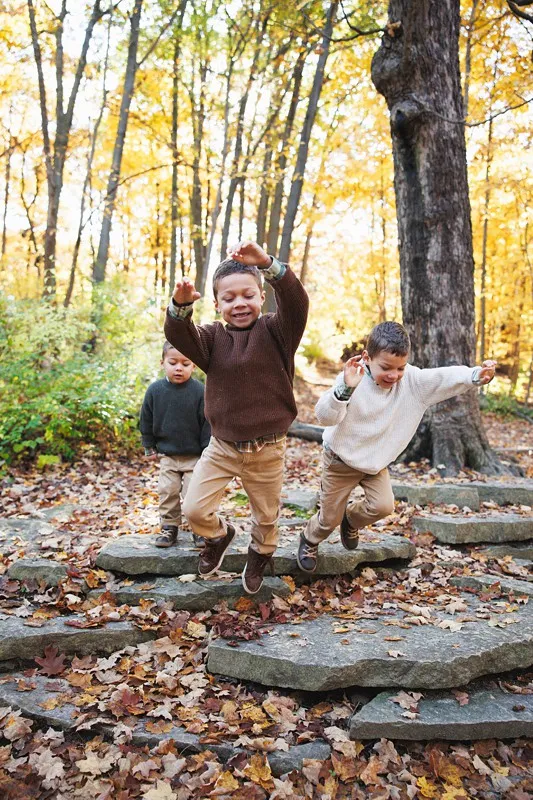 brother's jumping for family photos together
