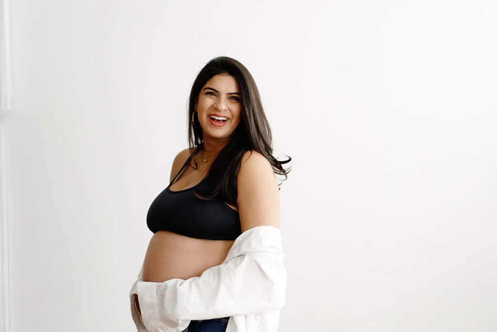 mom in white button down and black sports bra