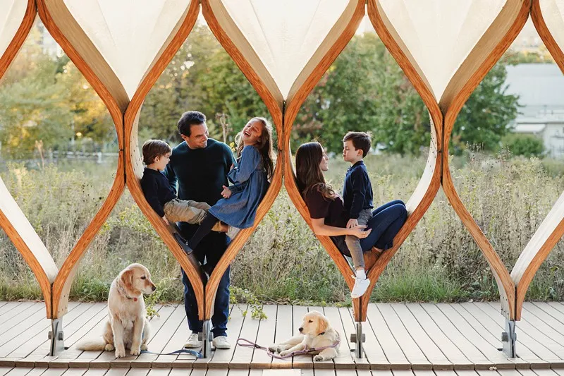 a family of five poses in the honeycombs at south pond in lincoln park chicago