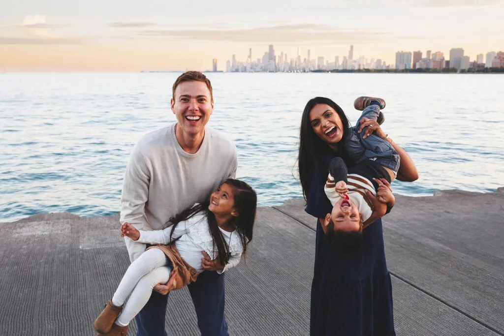 Family photos in Chicago at golden hour with parents and kids walking near the lakefront