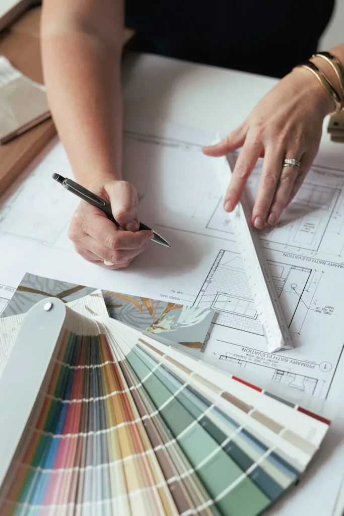 detail of hands writing notes about interior deisng